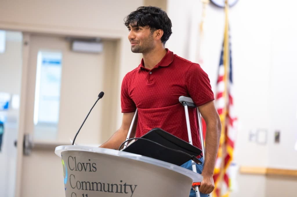 Amar speaking at a Clovis Community College podium