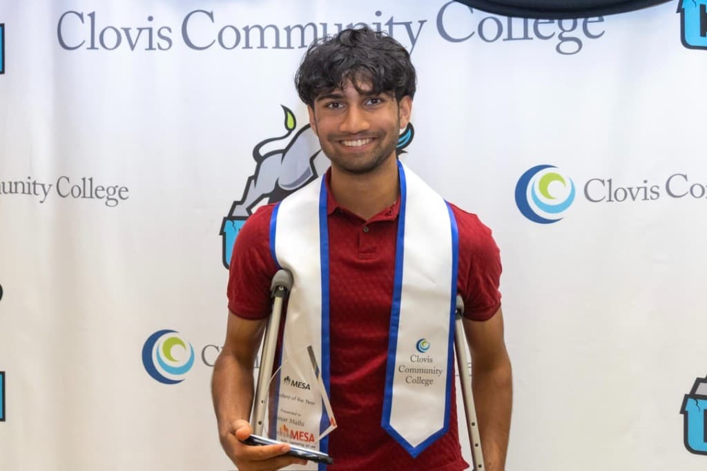 Amar holding a MESA Student of the Year award