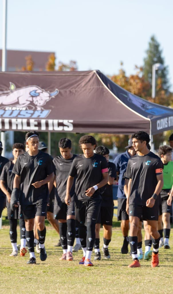Clovis Rush soccer team walking across the field