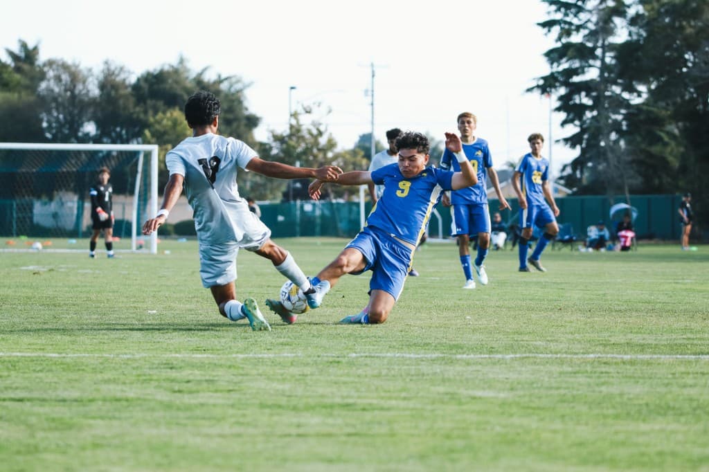 Amar sliding in to challenge for the ball during a soccer match