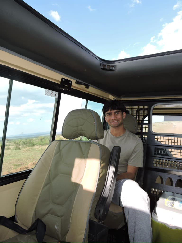 Amar smiling inside a safari jeep
