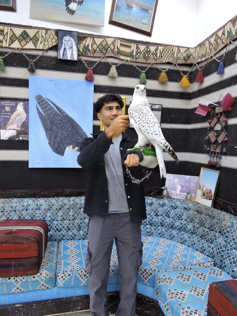Amar holding a falcon during a visit to Qatar